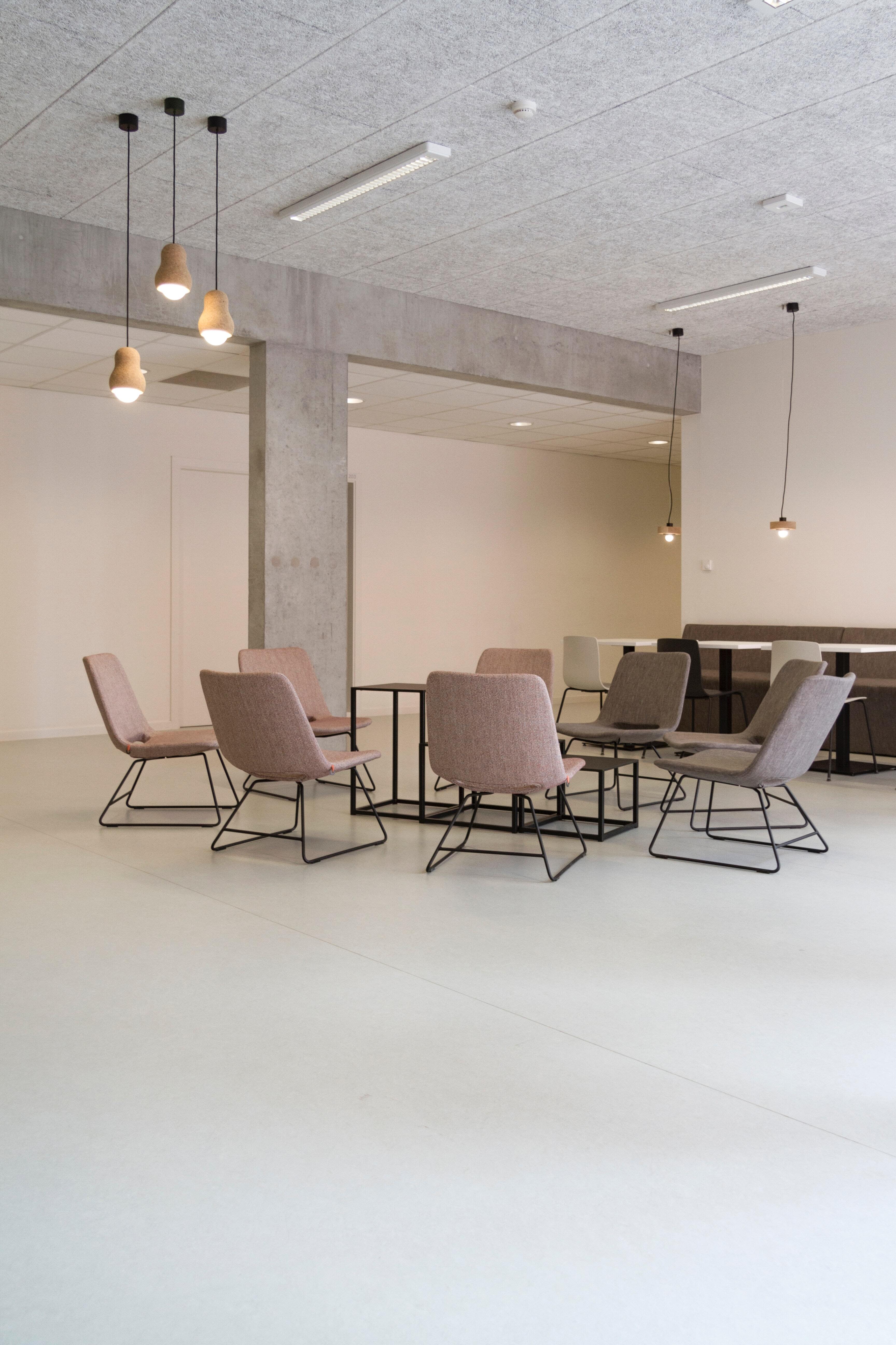 rectangular brown wooden table with chair lot inside building